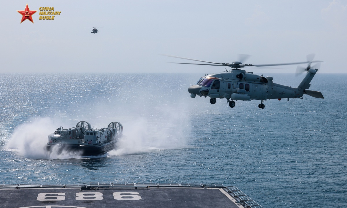 The amphibious dock landing ship Changbaishan (Hull 989) attached to a naval flotilla under the Chinese PLA Southern Theater Command conducts joint operations in coordination with Z-20J ship-borne helicopters and a landing craft air cushion (LCAC) during a multi-subject maritime training exercise in mid to late July, 2026. Photo: Screenshot from eng.chinamil.com.cn