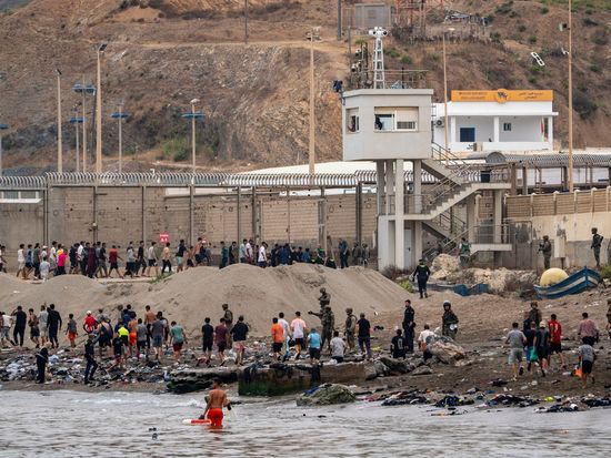 Tens of thousands cross into Spain's north Africa enclave in new migrant crisis