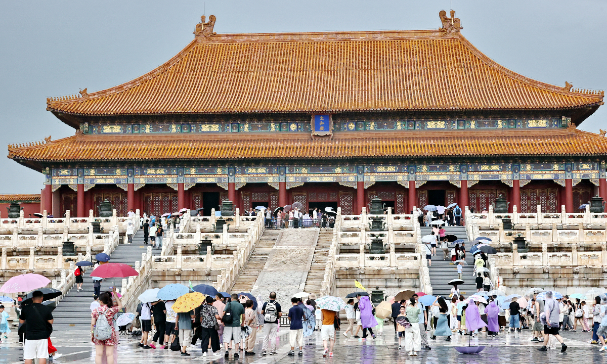 Visitors toured the Palace Museum during heavy rain after a sudden downpour in Beijing on August 2, 2026. Photo: VCG