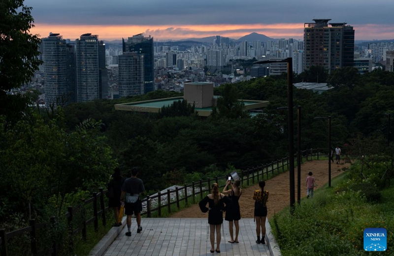 Tourists enjoy the scenery around the Namsan Seoul Tower in Seoul, South Korea, July, 18, 2026. (Photo by Jun Hyosang/Xinhua)