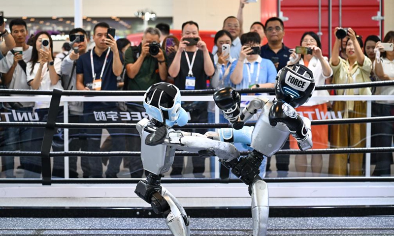 People watch humanoid robots of Unitree Robotics boxing at the World Intelligence Expo 2026 in Tianjin, north China, May 28, 2026. (Xinhua/Sun Fanyue)