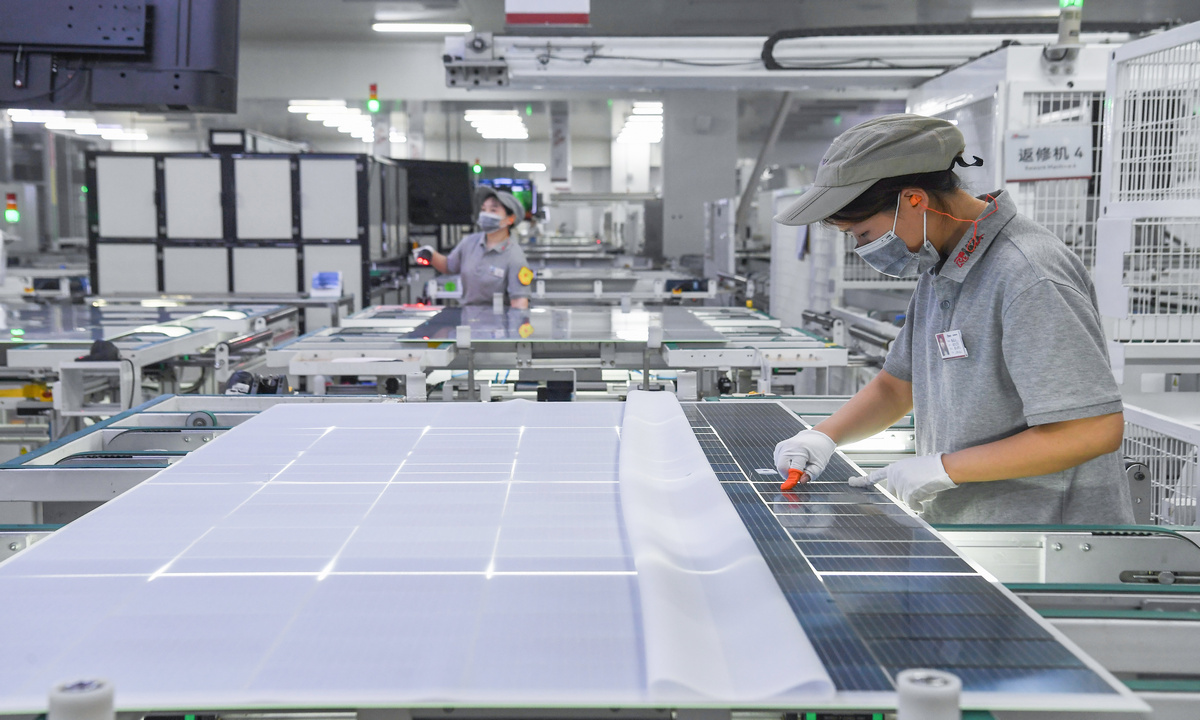 Workers assemble solar photovoltaic modules at a smart manufacturing workshop of Ronma Solar Energy Group in Jindong district of Jinhua city, East China’s Zhejiang Province, on July 28, 2026. As the company boosts production capacity and expands overseas sales channels, its products are being exported to Europe, Southeast Asia, the Middle East, and Africa. Photo: VCG