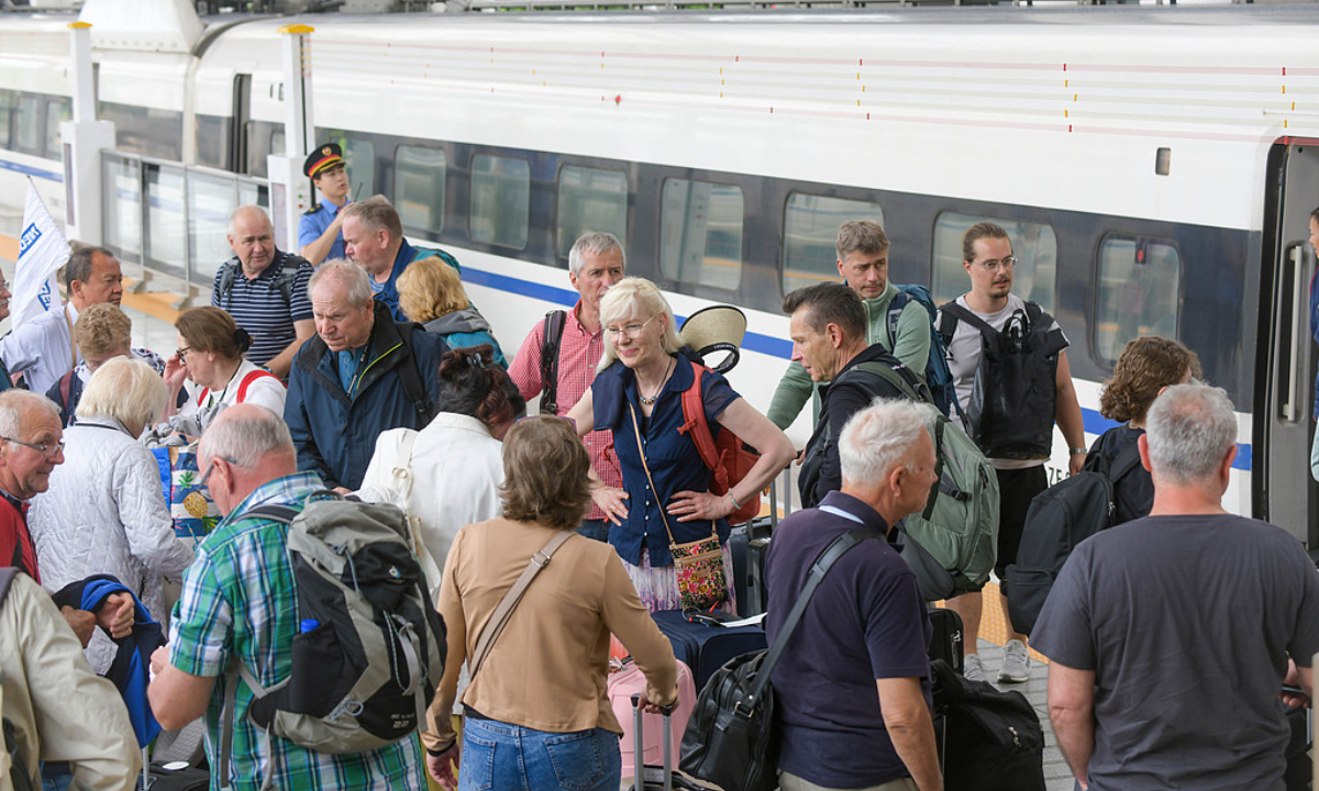 Foreign tourists wait to board a high-speed train at Luoyang Longmen Railway Station in Luoyang, Central China's Henan Province, on May 1, 2026.