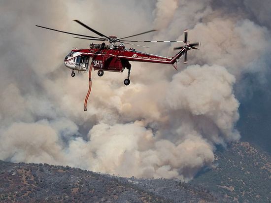 Wildfires spread across North America and Europe, two killed in Utah helicopter crash