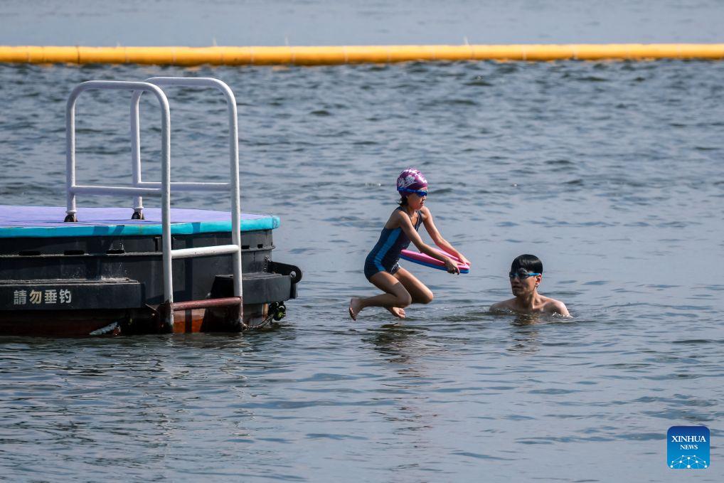 People swim in the sea in Hong Kong, south China, Aug. 9, 2026.Hong Kong's temperature had reached 36.9 degrees Celsius by 3:30 p.m. on Sunday, the highest since the city started keeping meteorological records in 1884, according to the Hong Kong Observatory. (Xinhua/Lui Sui Wai)