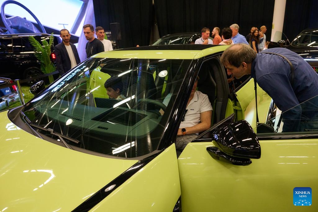 Visitors view an Xpeng electric vehicle at Expo Georgia in Tbilisi, Georgia, June 13, 2026. This year's expo was held here from Saturday to Sunday. Chinese automakers including BYD, XPeng, AVATR and JAC Motors have made appearances with their products at the expo. (Photo: Xinhua)