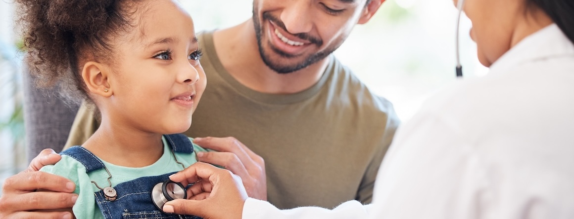 A child gets their heart checked by a doctor