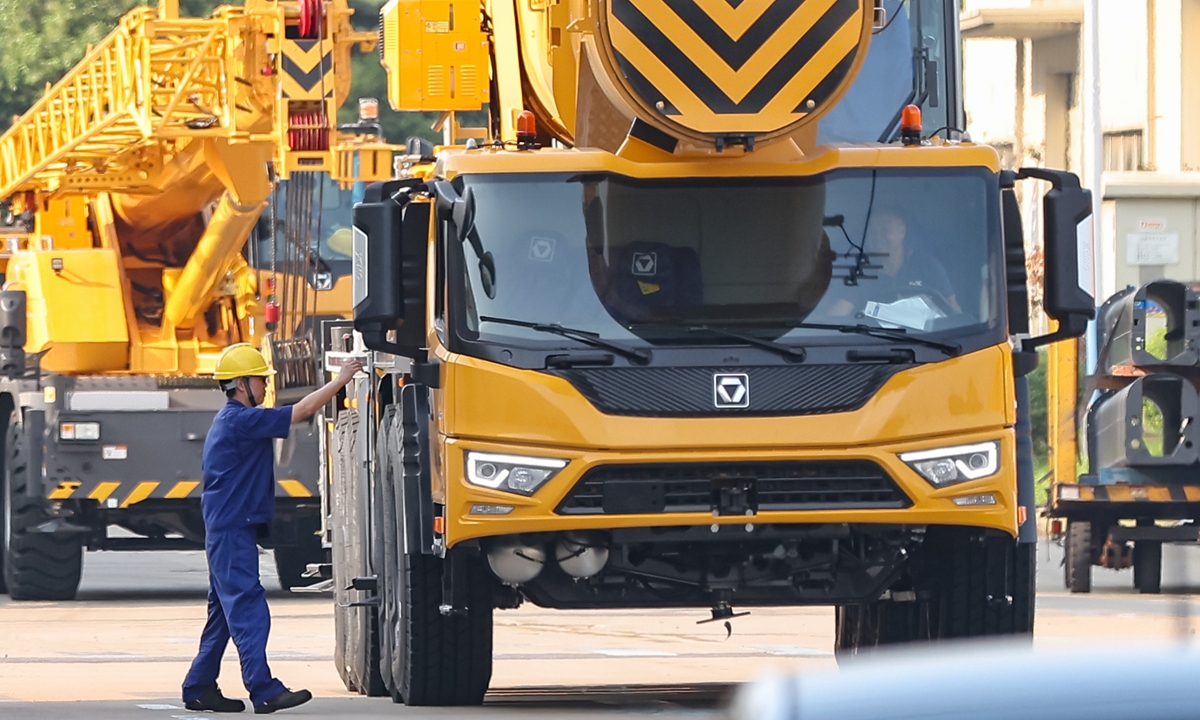 A worker checks finished truck?mounted cranes at a manufacturer in Xuzhou, East China's Jiangsu Province on August 17, 2026. According to China's National Bureau of Statistics, the value?added of industrial enterprises above designated size grew by 4.5 percent year?on?year in real terms in July 2026. Photo: VCG