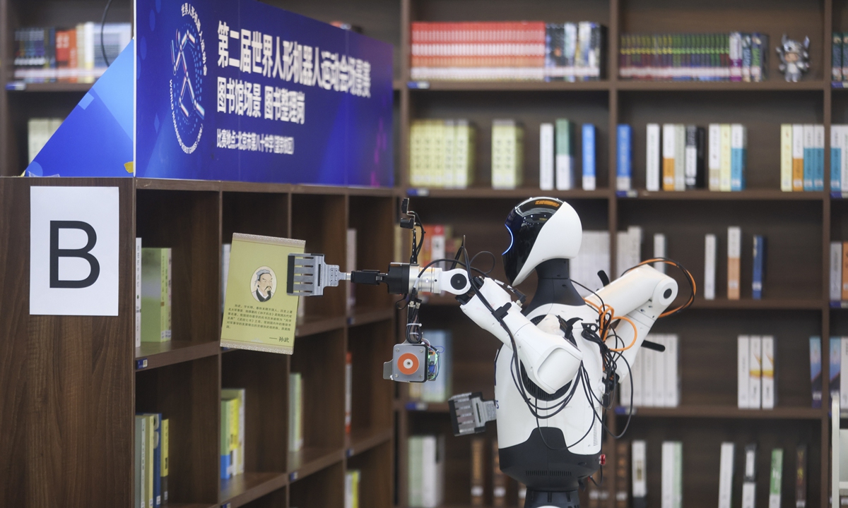 A robot competitor checks bookshelves for misplaced books during a library scenario event at the second World Humanoid Robot Games in Beijing on August 16, 2026. Photo: VCG