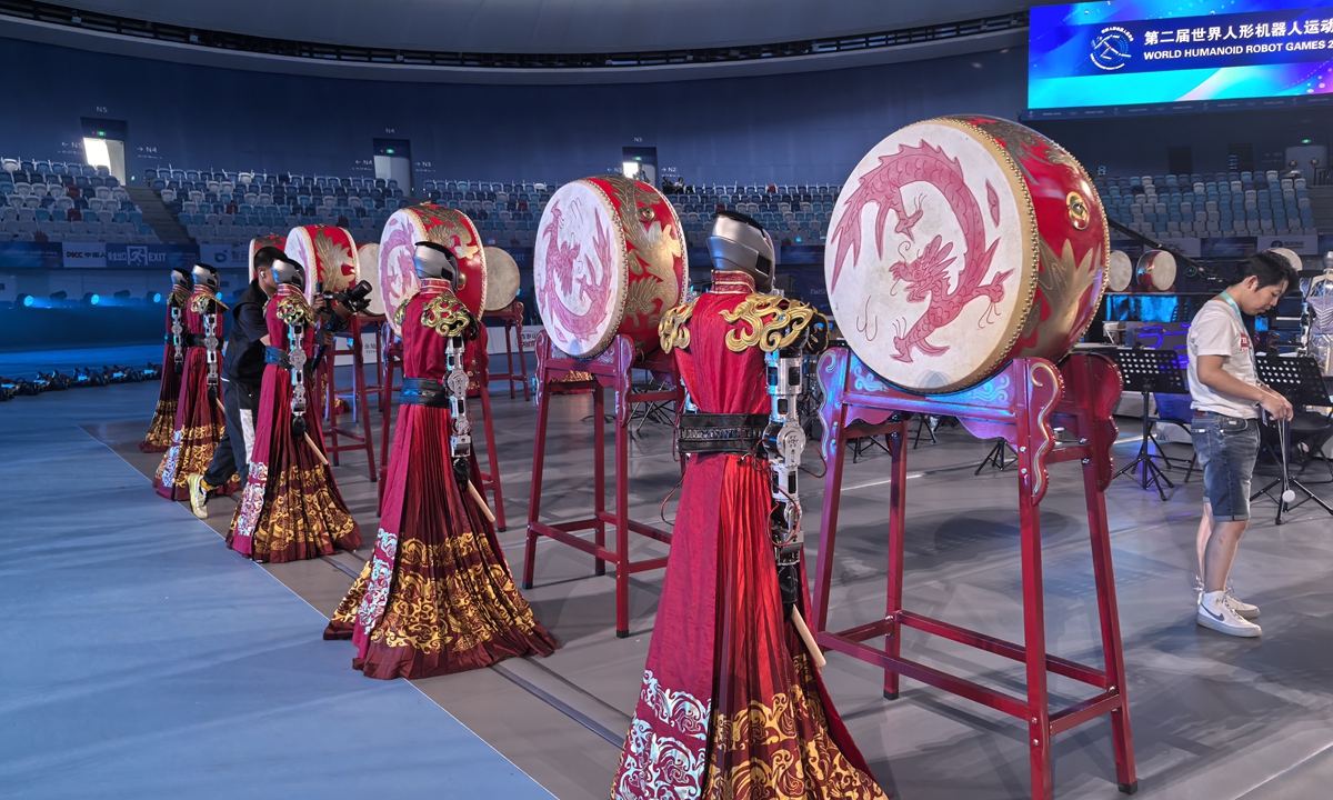 Humanoid robots stand at Chinese drums during a rehearsal for the opening ceremony of the 2nd World Humanoid Robot Games at the National Speed Skating Oval in Beijing on August 21, 2026. Photo: Zhang Yiyi/GT