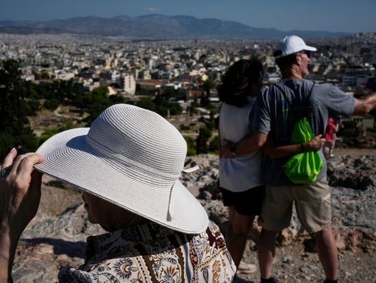 The sunhat is everywhere in Athens as crowds grow larger at ancient sites
