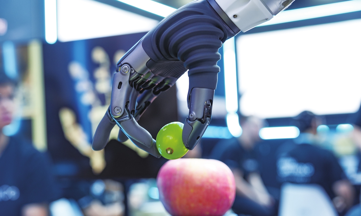 A dexterous robotic hand picks up a grape during a demonstration at the 2026 World Robot Conference in Beijing on August 21, 2026. Photo: VCG