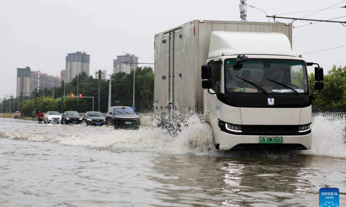 Vehicles drive through a waterlogged street in Shenyang, northeast China's Liaoning Province, Aug. 24, 2026. Heavy to torrential rains lashed southeastern Liaoning from 8 a.m. Sunday to 11 a.m. Monday, with downpours in some areas, while northern and western parts of the province saw light to moderate rain and localized heavy to torrential rains in a few spots.Red alerts for torrential rain remain in effect across multiple parts of Liaoning. As of 6 a.m. Monday, nine cities had activated flood emergency responses, according to the provincial flood control and drought relief headquarters. (Xinhua/Li Gang)