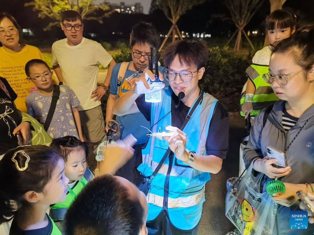 People participate in a nighttime insect science popularization event at Shanghai Century Park in east China's Shanghai, Aug. 1, 2026. (Xinhua/Chen Aiping)