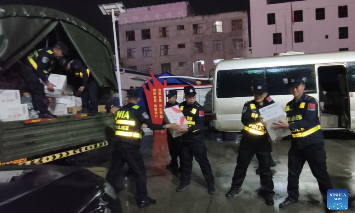 Police officers carry disaster relief supplies in southwest China's Xizang Autonomous Region, Aug. 26, 2026. Rescue teams are racing to a mudslide-stricken border port in southwest China's Xizang Autonomous Region after the disaster caused significant casualties along the China-Nepal border on Wednesday, local authorities said. A mudslide occurred on Wednesday morning in Nepal, resulting in three people dead and 265 missing at Gyirong Port in Gyirong County of Xizang as of 8 p.m., according to initial estimates. (Xinhua)