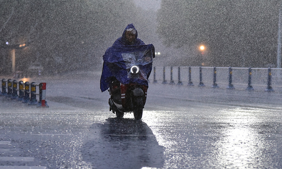 A resident in Fuyang, East China's Anhui Province, travels through heavy rain on August 30, 2026. The city experienced severe rainfall that day under the influence of the remnants of Typhoon Saudel. Photo: VCG