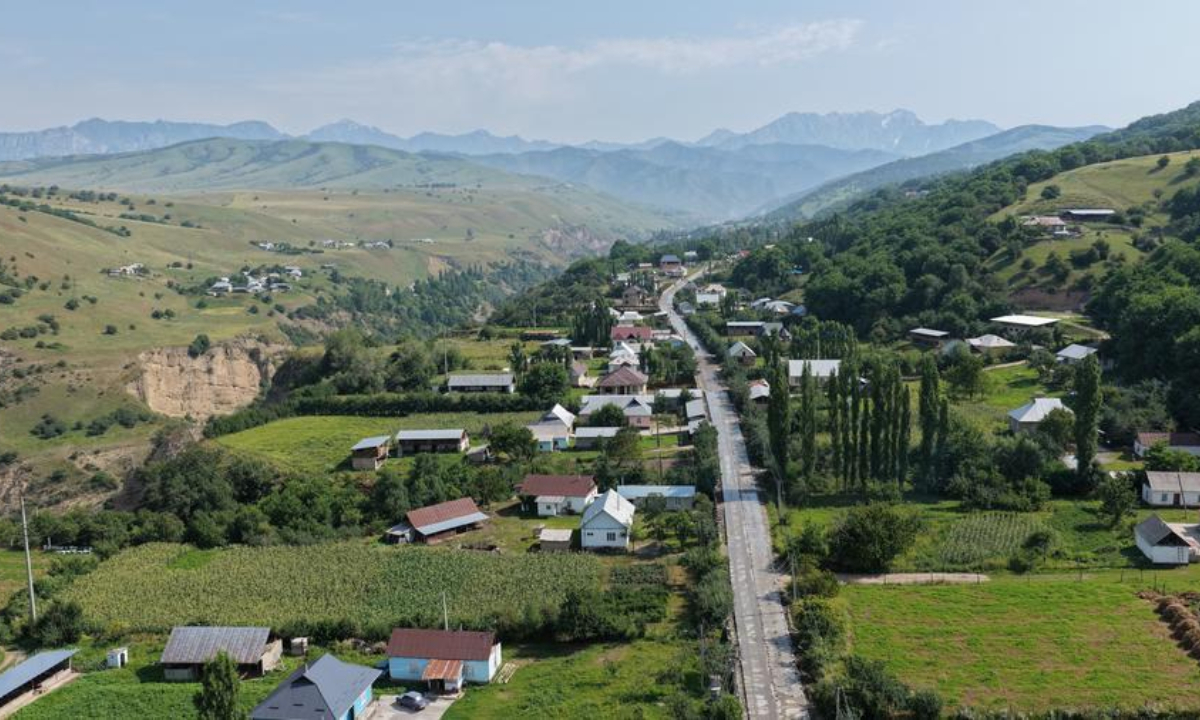 An aerial drone photo taken on May 9, 2026 shows a village road repaired by a project department of the China-Kyrgyzstan-Uzbekistan railway in Jalalabad, Kyrgyzstan. (Photo by Ren Weiyun/Xinhua)