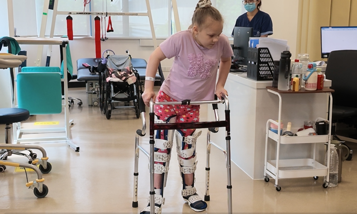 Russian girl Vera uses assistive equipment to stand and walk. Photo: Tide News