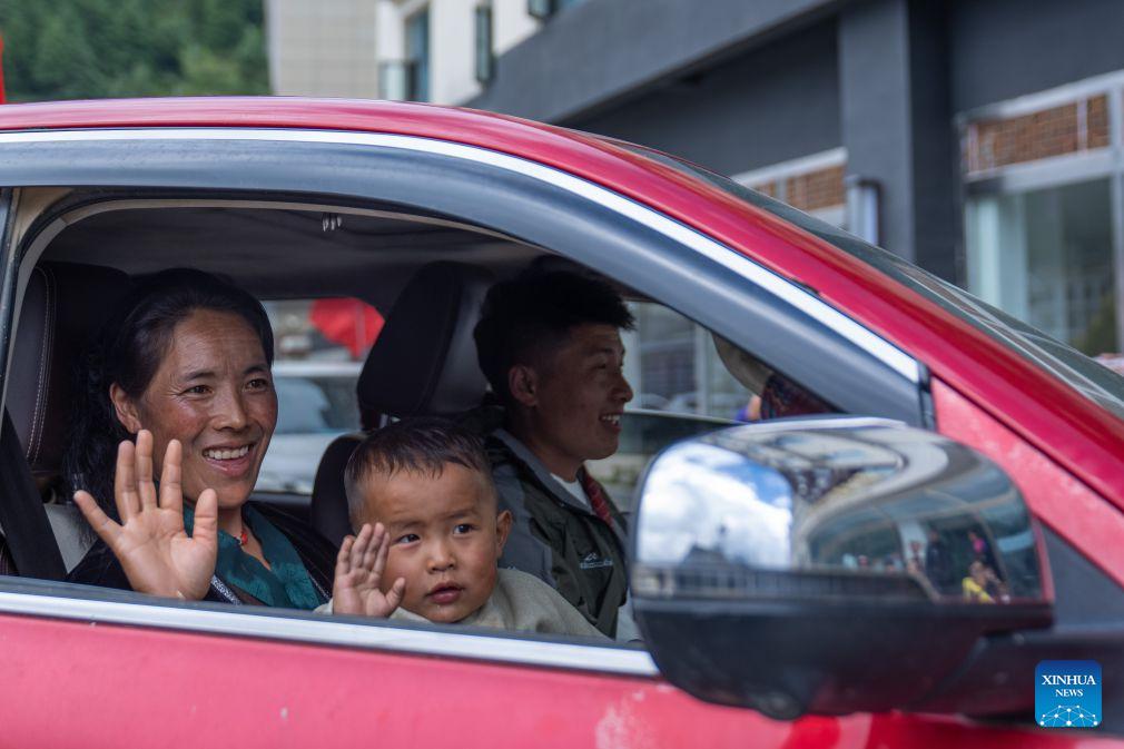 People take a vehicle and return home from a temporary relocation site in Gyirong Town, southwest China's Xizang Autonomous Region, Sept. 7, 2026. A fast-moving chain mudslide, triggered by a high-altitude glacier collapse in Nepal, struck Gyirong Port on the China-Nepal border in southwest China's Xizang Autonomous Region on Aug. 26, causing heavy casualties and leaving many missing. A barrier lake caused by the mudslide posed a serious threat to the lives and safety of the residents in the surrounding villages.A total of 499 villagers were evacuated to Gyirong Town by the local authorities for their safety and experts were organized to carry out hidden danger investigations and hydrological monitoring to assess the risks of secondary disasters.By far, the barrier lake on the upper reaches of the core affected zone of the mudslide-hit Gyirong Port has been drained. The local government has dispatched vehicles to transfer the affected people home in succession. On Monday, residents at the temporary relocation sites of Gyirong Town started returning home in an orderly manner. (Xinhua/Tenzing Nima Qadhup)