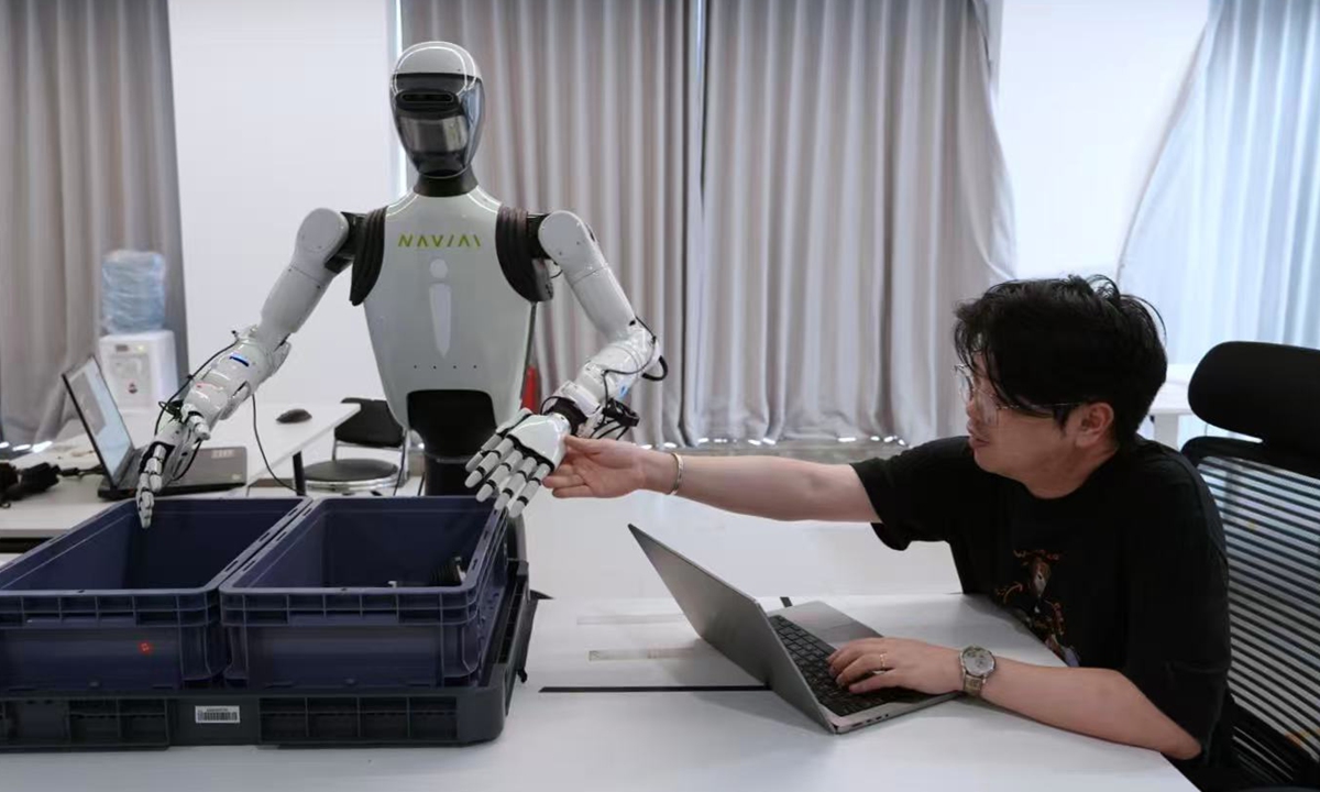 Jiang Zebin tests and fine-tunes the movements of a humanoid robot in the lab in Ningbo, East China's Zhejiang Province, on September 9, 2026. Photo: Courtesy of Jiang Zebin

