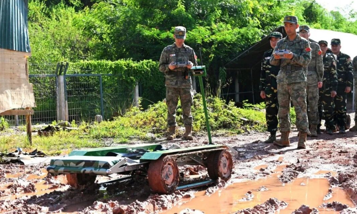 An unmanned ground vehicle operates on a muddy road. Photo: China Military Bugle