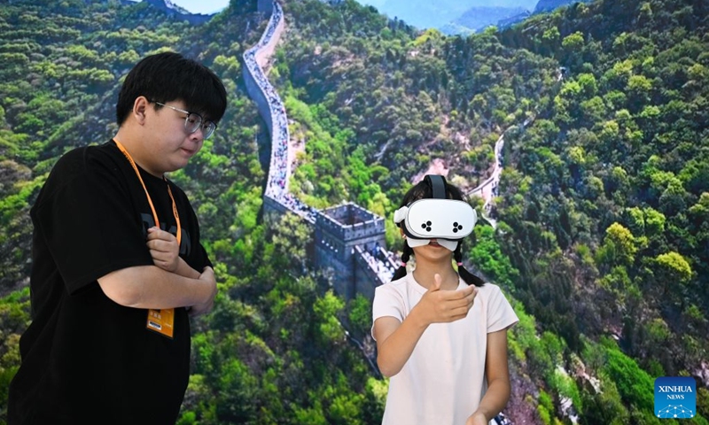 A child views the scenery of the Great Wall via a VR device at the themed exhibition area for culture and tourism services during the 2026 China International Fair for Trade in Services (CIFTIS) at Shougang Park in Beijing, capital of China, Sept. 12, 2026. The 2026 CIFTIS, running from Sept. 9 to 13 at Shougang Park in Beijing, has brought together 413 exhibitors at the themed exhibition area for culture and tourism services, showcasing emerging models of cultural and tourism integration. (Xinhua/Zheng Huansong)