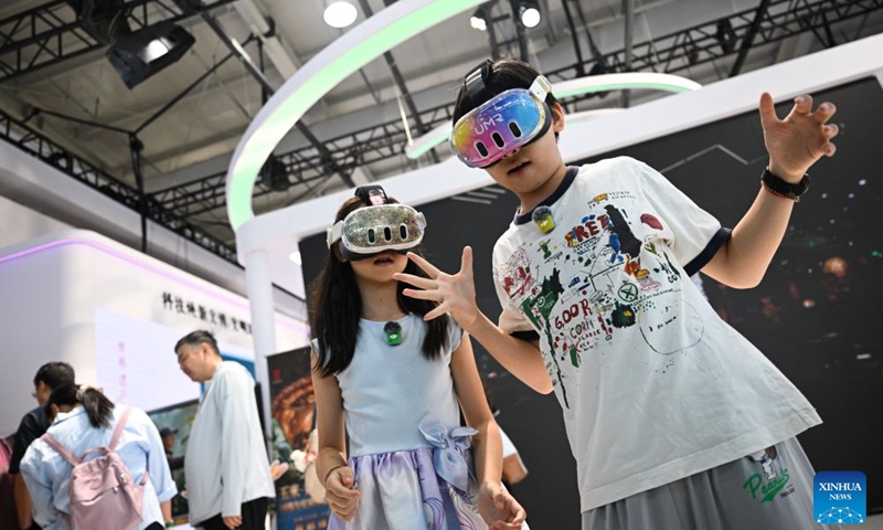 Children try VR devices at the themed exhibition area for culture and tourism services during the 2026 China International Fair for Trade in Services (CIFTIS) at Shougang Park in Beijing, capital of China, Sept. 12, 2026. The 2026 CIFTIS, running from Sept. 9 to 13 at Shougang Park in Beijing, has brought together 413 exhibitors at the themed exhibition area for culture and tourism services, showcasing emerging models of cultural and tourism integration. (Xinhua/Zheng Huansong)