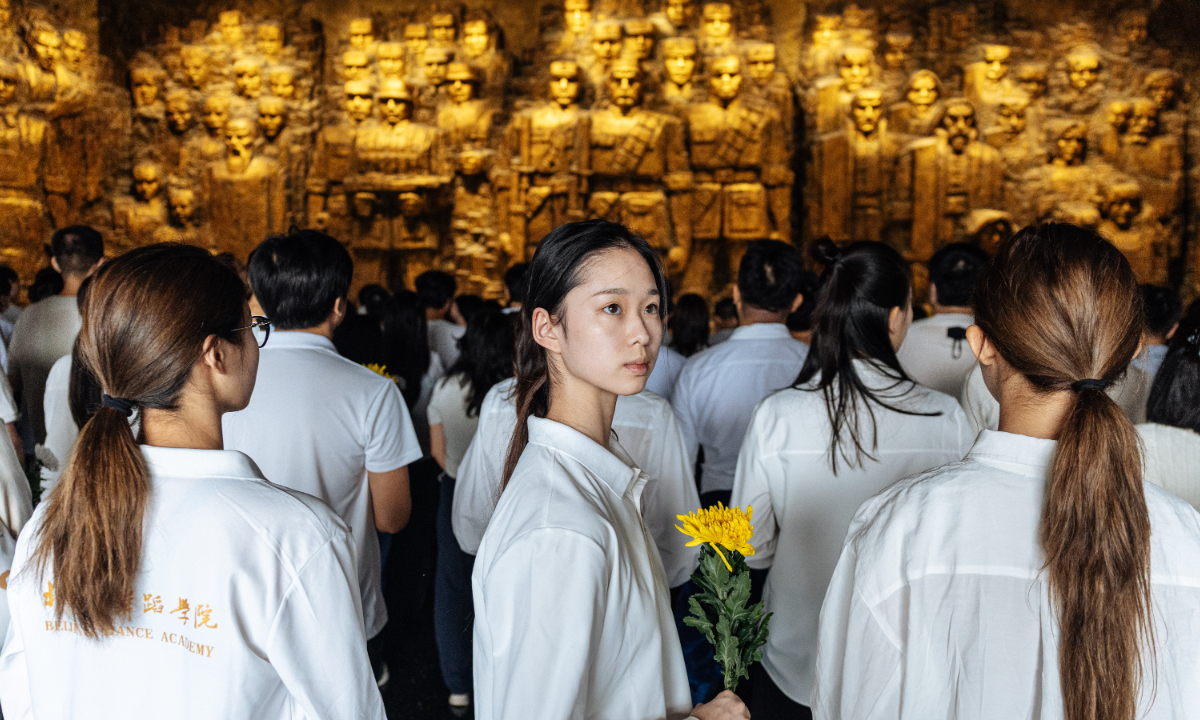 A participant holds a yellow chrysanthemum at “Remember History, Never Forget September 18,” a commemorative event hosted by the Museum of the War of Chinese People’s Resistance Against Japanese Aggression in Beijing on September 18, 2026. Photo: Li Hao/GT