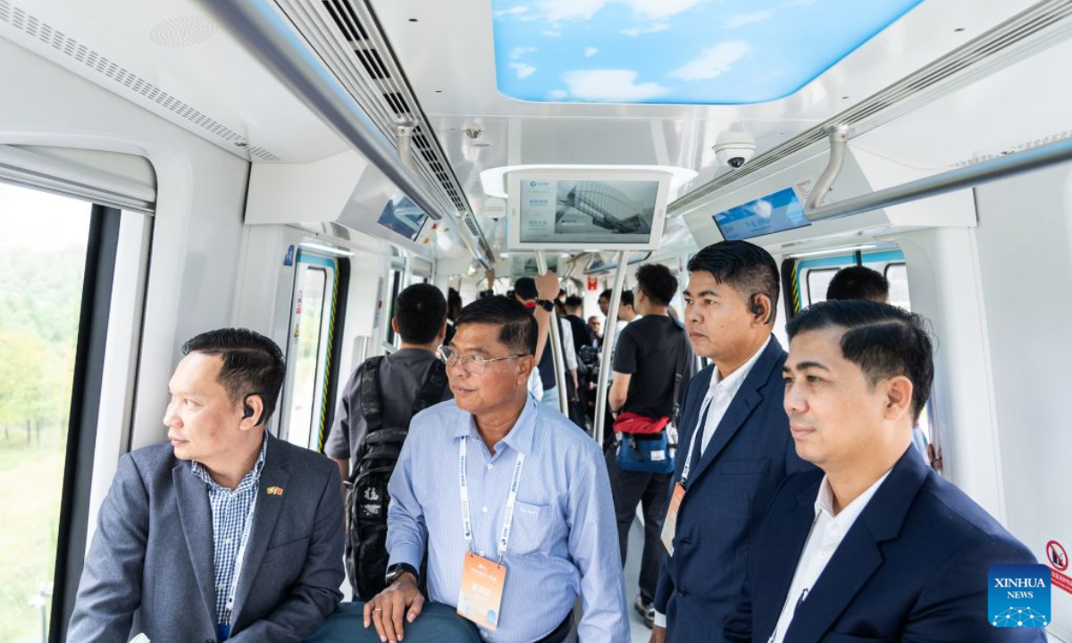 Foreign guests try a train trip running on the suspension monorail line during the 2026 Global Mayors Dialogue - Wuhan in Wuhan, central China's Hubei Province, Sept. 19, 2026. (Photo by Ren Yong/Xinhua)