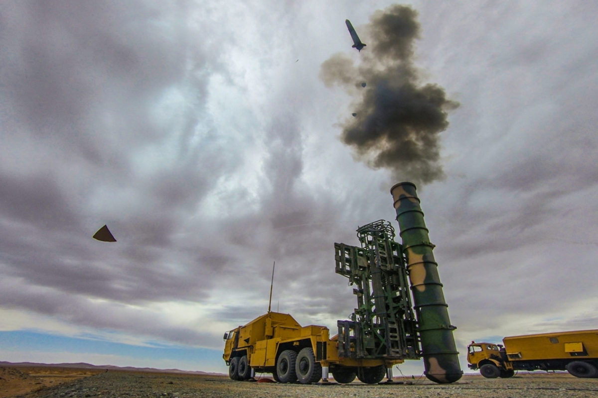 An HQ-9 long-range air defense missile system launcher in yellow camouflage fires a missile in the Gobi Desert. Photo: PLA Eastern Theater Command's WeChat account