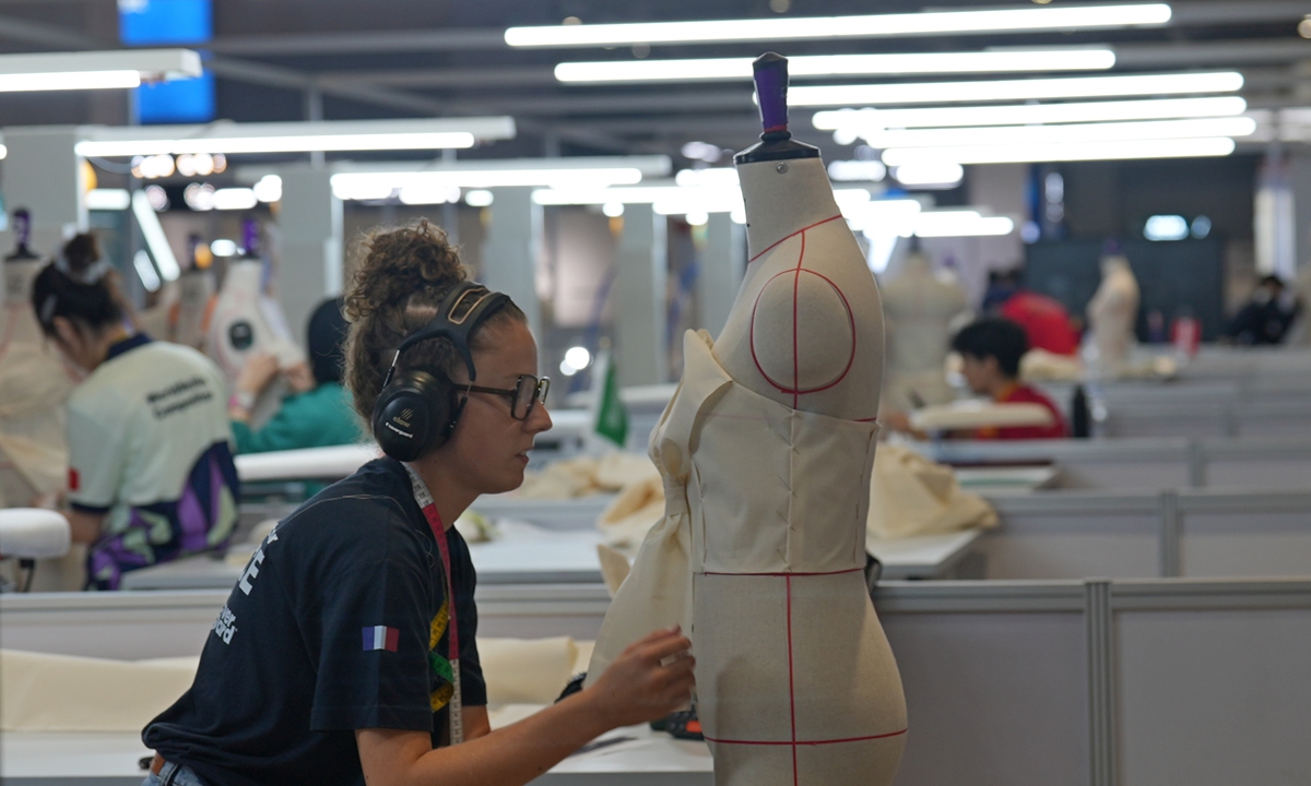A contestant works on a garment during the Fashion Technology competition at the 48th WorldSkills Competition in Shanghai on September 23, 2026. Photo: Pang Yue/GT