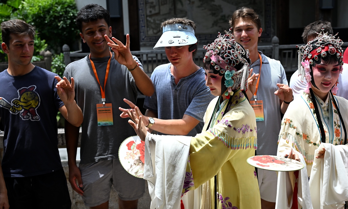 Young American participants learn traditional hand movements from Min Opera performers during a cultural exchange activity in Fuzhou, Fujian Province, on July 1, 2026. Photo: IC