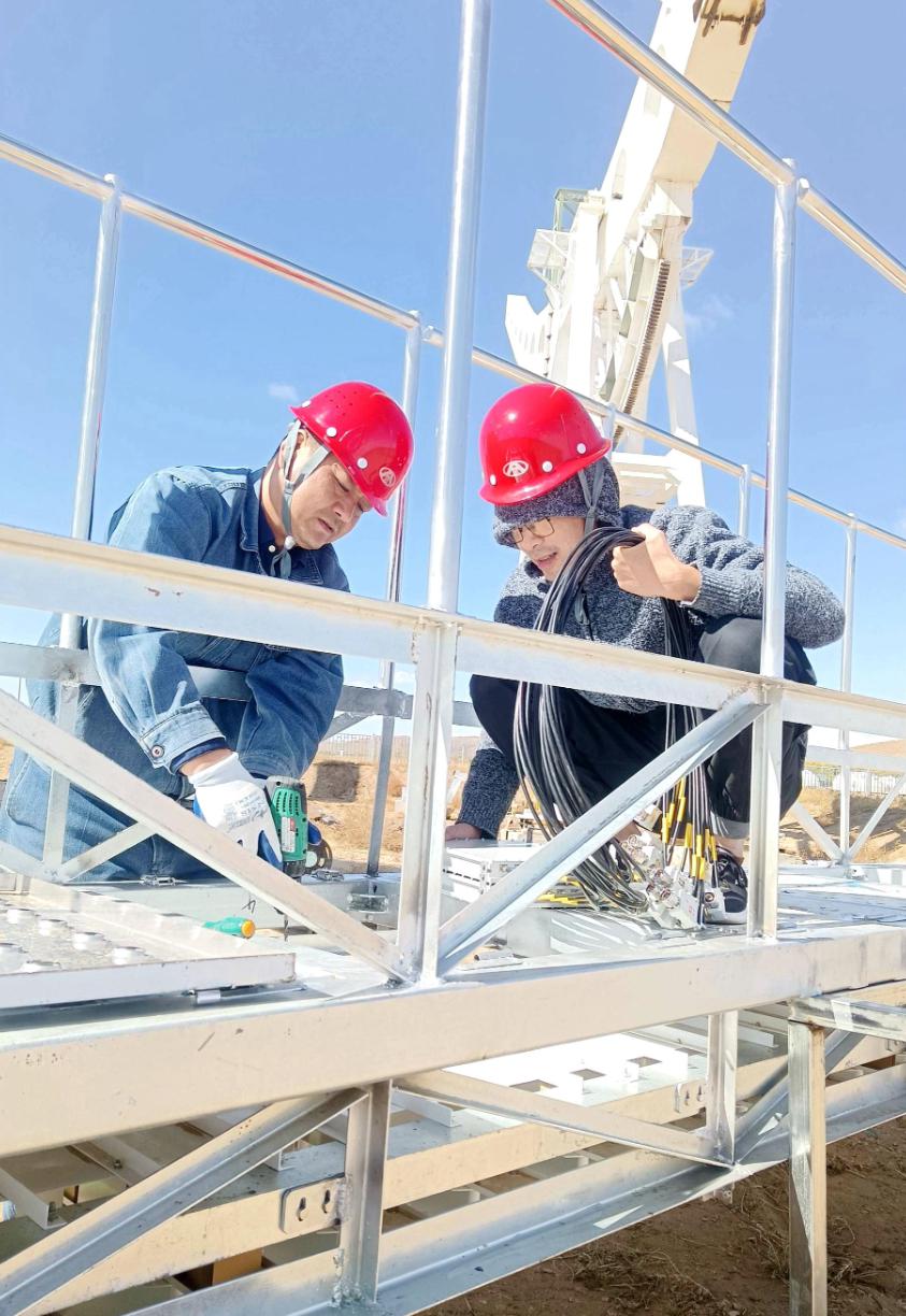 Workers install the interplanetary scintillation telescope receiver. Photo: Courtesy of CETC 16th Research Institute