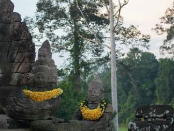 Cambodia reattaches 2 ancient deity statue heads at Angkor Thom's gate in Angkor complex