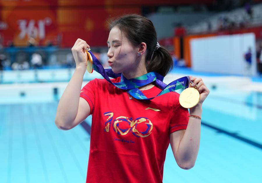 Chen Yuxi of China, gold medalist of the women's 10m platform and women's synchronised 10m platform, poses for photos after diving competition at the 20th Asian Games Aichi-Nagoya 2026 in Tokyo, Japan, Sept. 30, 2026. (Xinhua/Chen Zeguo)