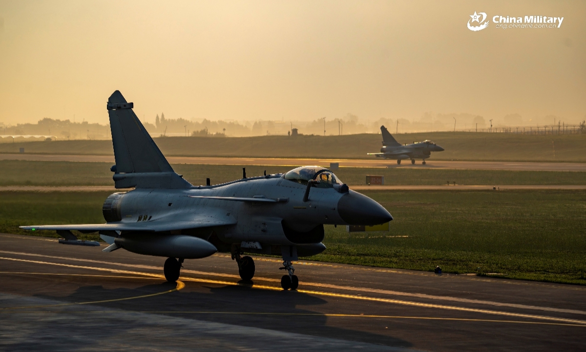 Two J-10 fighter jets attached to an aviation brigade with the air force under the Chinese PLA Southern Theater Command taxi on the runway after returning from a nighttime flight training exercise in recent days. (eng.chinamil.com.cn/Photo by Xiao Rui)