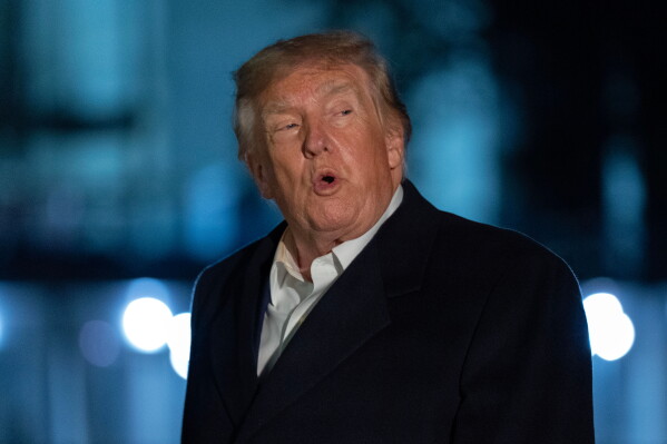 President Donald Trump talks to reporters as he walks on the South Lawn upon his arrival to the White House, Thursday, Oct. 8, 2026, in Washington. (AP Photo/Jose Luis Magana)