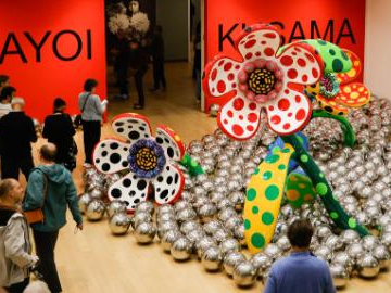 Visitors view art works of Yayoi Kusama at Stedelijk Museum in Amsterdam