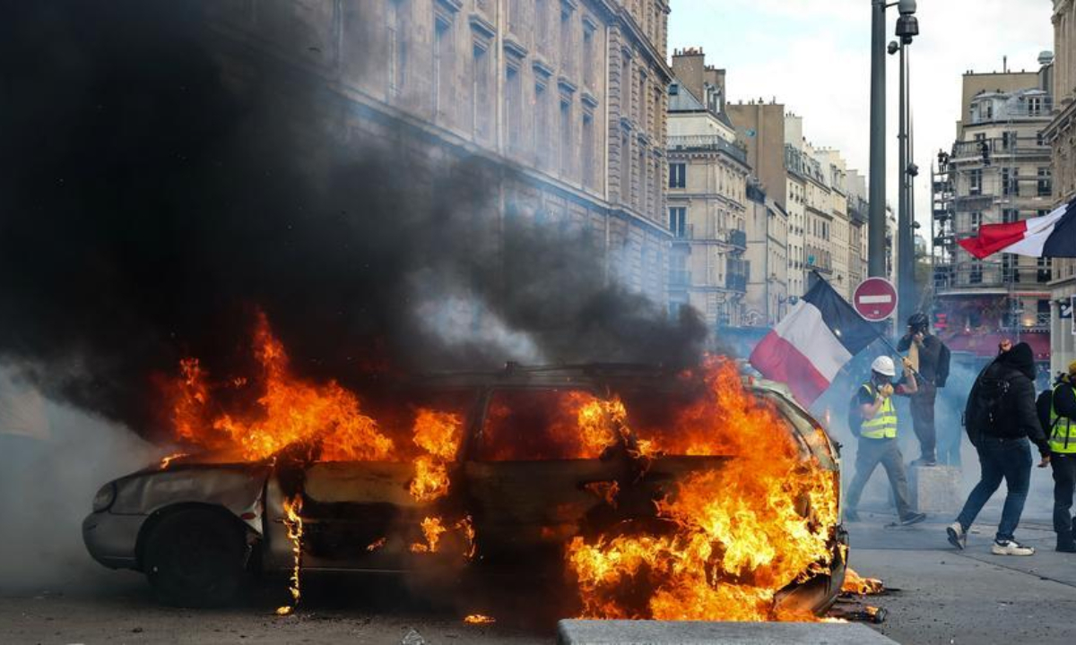 This photo taken on Oct. 17, 2026 shows a burning vehicle during a protest in Paris, France. (Xinhua/Wu Huiwo)