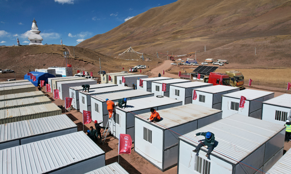 Power workers install electricity connections for prefabricated shelters at a temporary relocation site in Maru Township, Baqen County in Southwest China's Xizang Autonomous Region, on October 25, 2026. Photo: IC