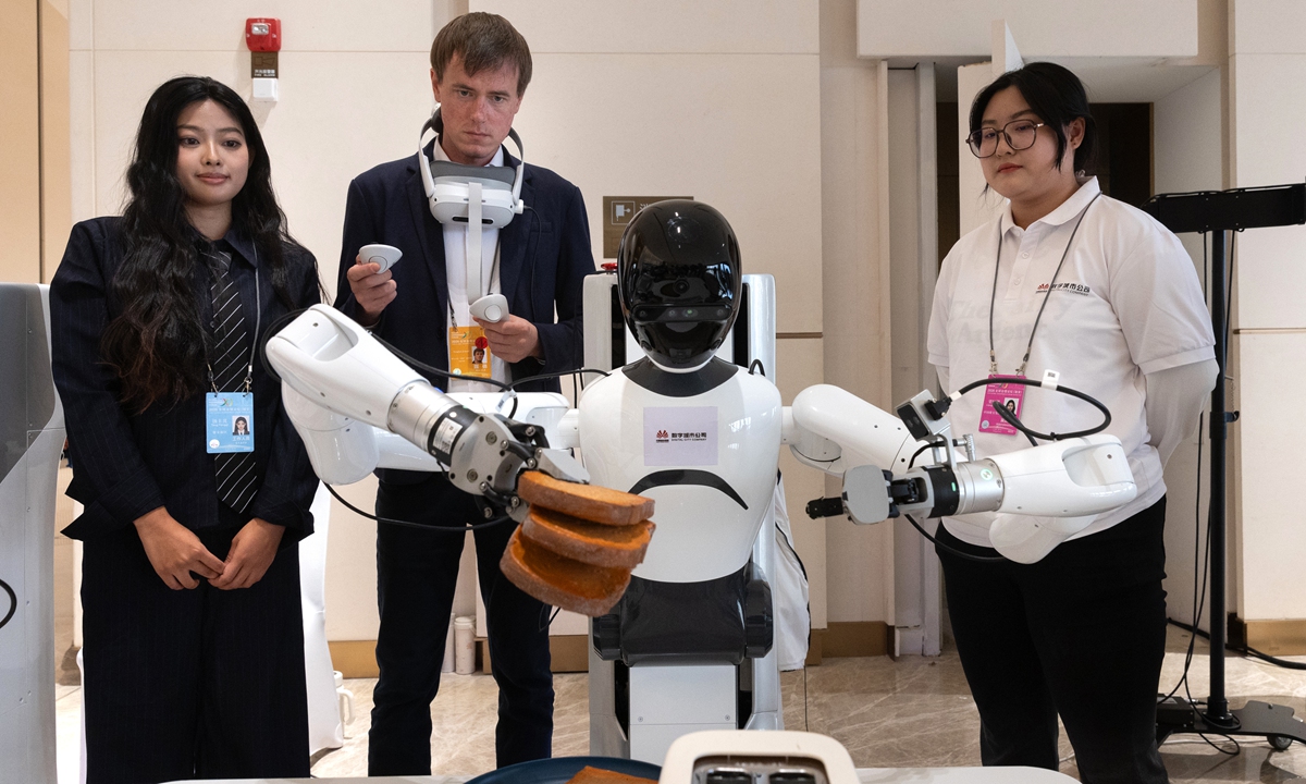 A participant tests a robot during the 2026 Global Governance Forum in Xiong'an, Hebei, on October 23, 2026.