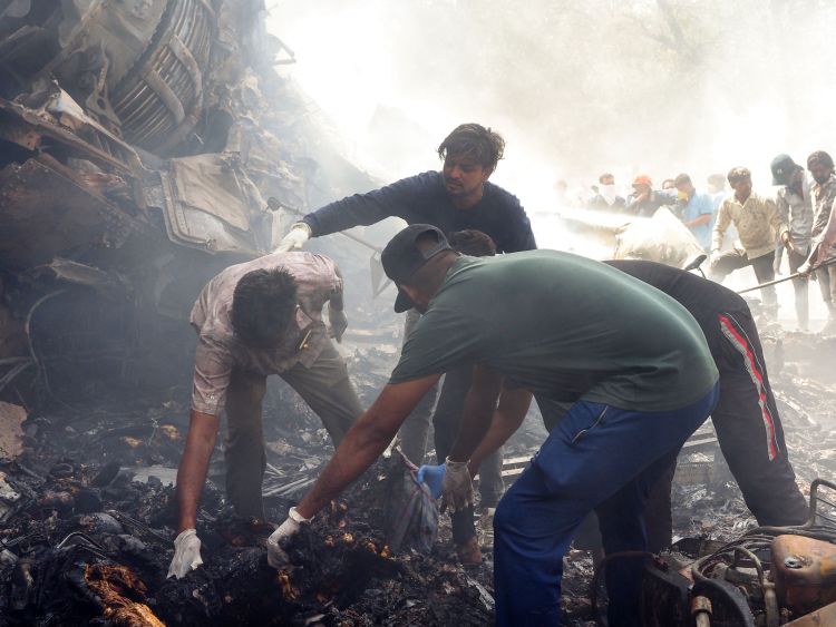 Flames and smoke in aftermath of crashed India passenger jet
