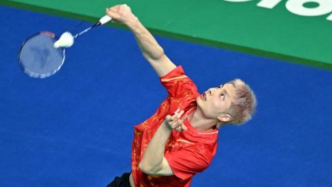 In pics: men's team group match of badminton at National Games