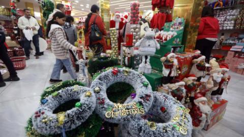Customers select Christmas decorations at shop in Cairo, Egypt