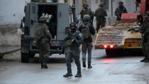 Israeli forces stand guard during house demolition in West Bank