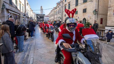 Bikers dressed as Santa Claus drive motorcycles during parade in Croatia