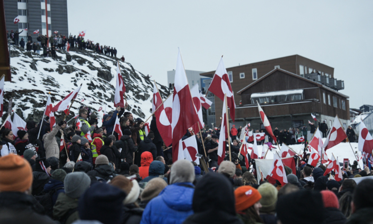 People wave Greenlandic flags as they take part in a demonstration that gathered almost a third of the city population to protest against the US President's plans to take Greenland, on January 17, 2026 in Nuuk, Greenland. Photo: VCG