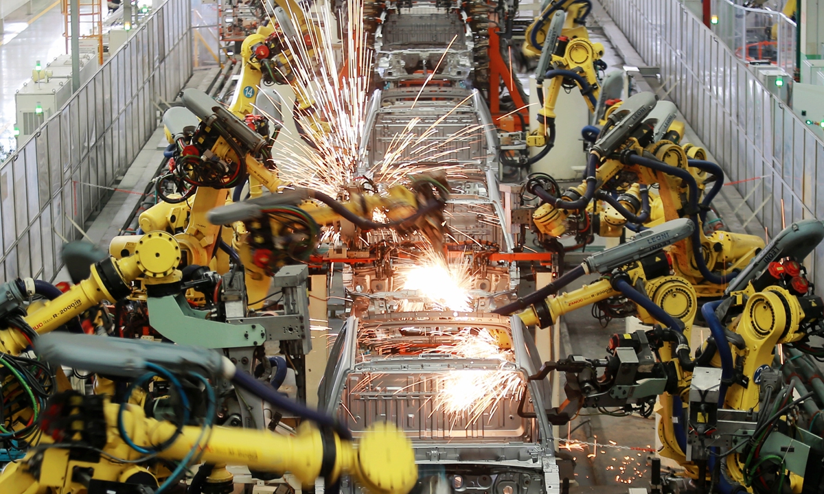 Industrial robots carry out welding operations in an intelligent workshop of an automobile manufacturer located in Jiangdu Hi-tech Industrial Development Zone, Yangzhou, East China’s Jiangsu Province, on October 18, 2024. China's GDP grew 4.8 percent year on year in the first nine months of 2024, data from the National Bureau of Statistics (NBS) showed on the day. Photo: VCG