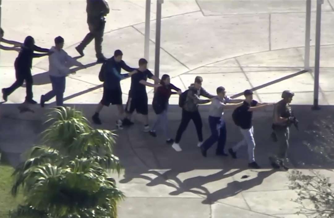 Slide 9 of 11: In this frame grab from video provided by WPLG-TV, students from the Marjory Stoneman Douglas High School in Parkland, Fla., evacuate the school following a shooting, Wednesday, Feb. 14, 2018.
