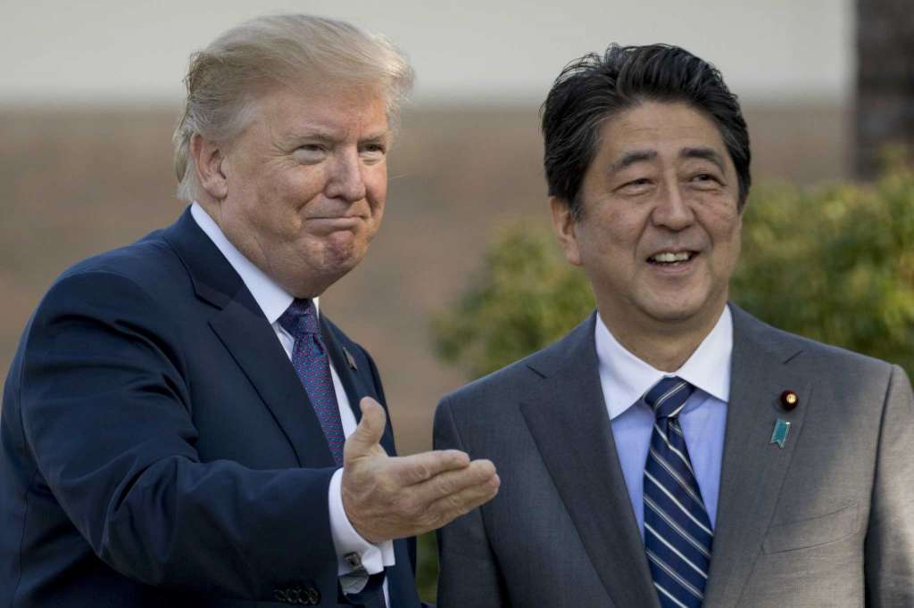 Image result for US President Donald Trump shakes hands with Japan’s Prime Minister Shinzo Abe at Kasumigaseki Country Club in Kawagoe, north of Tokyo, November 5, 2017.